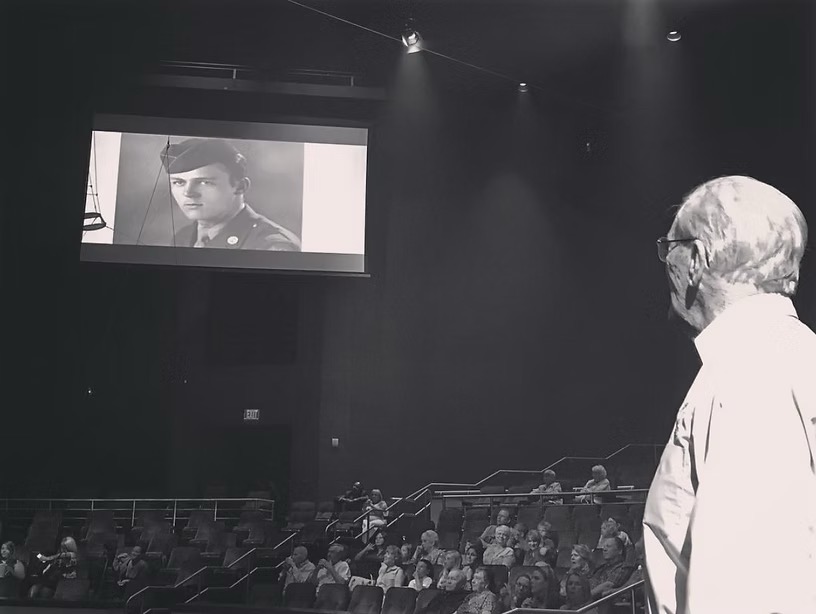 Jack Oyster watches his veteran tribute video before an ALLUSA performance at Beau Rivage in 2017.